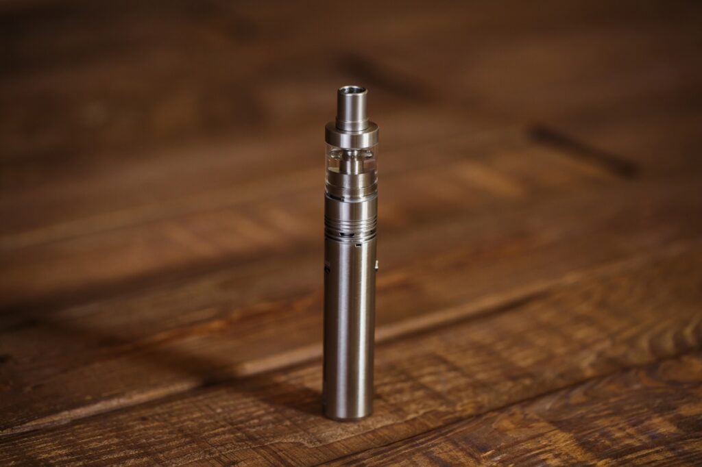 Electronic cigarette on a wooden table. Smoke